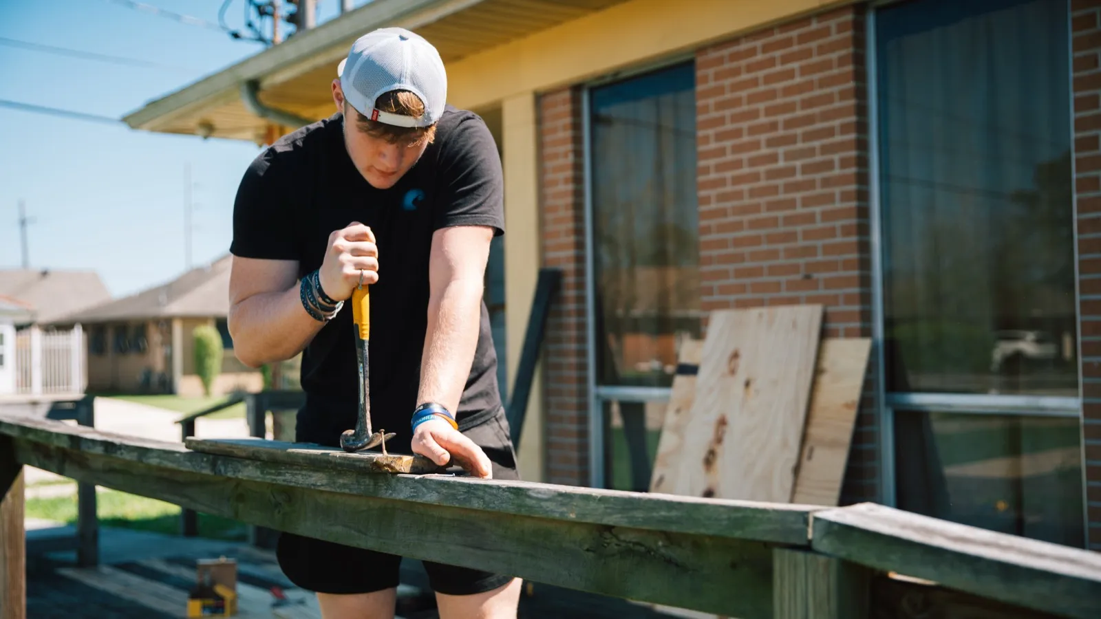 Adult volunteer building a deck railing